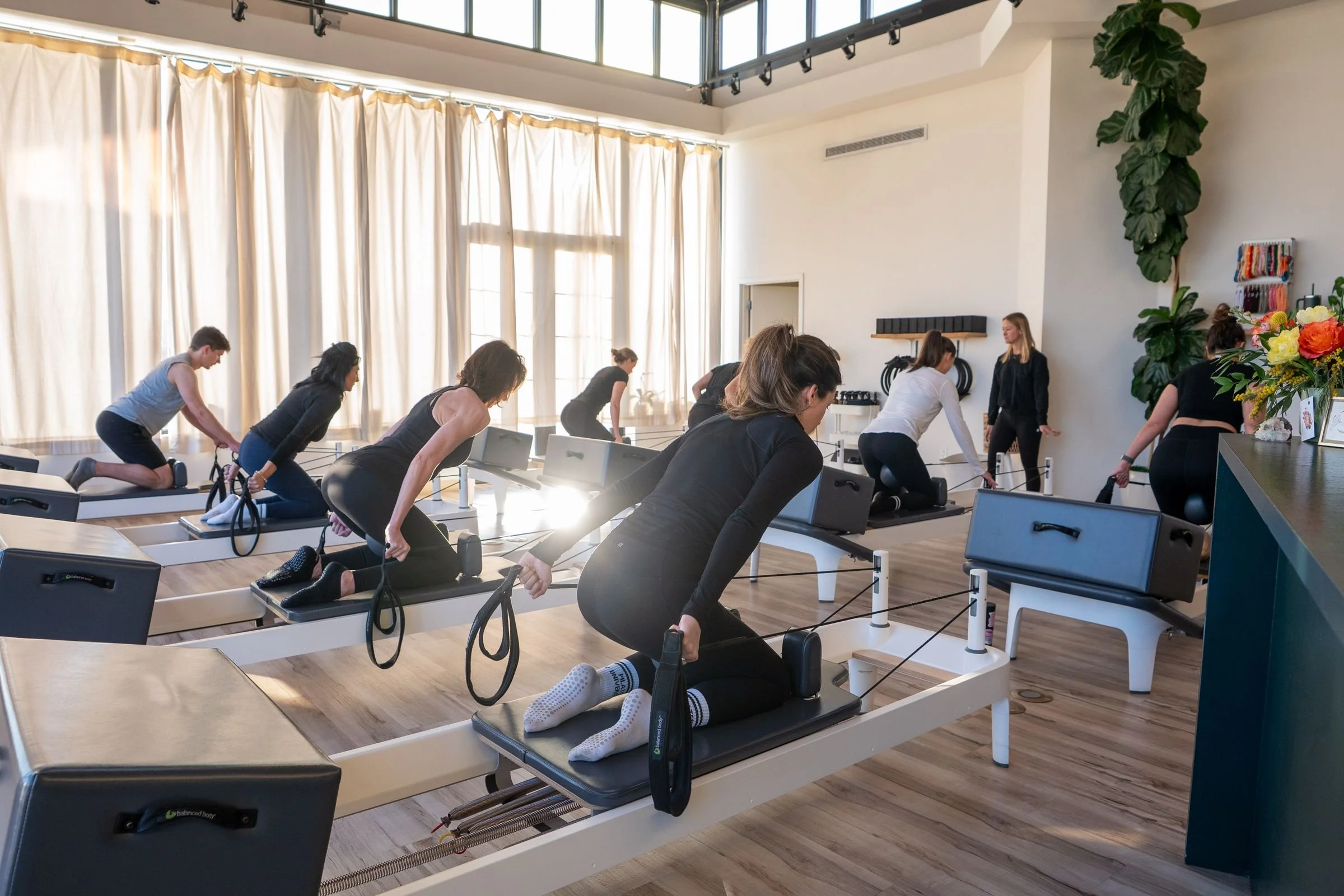 Wide view of the Care·To studio — reformers in natural light