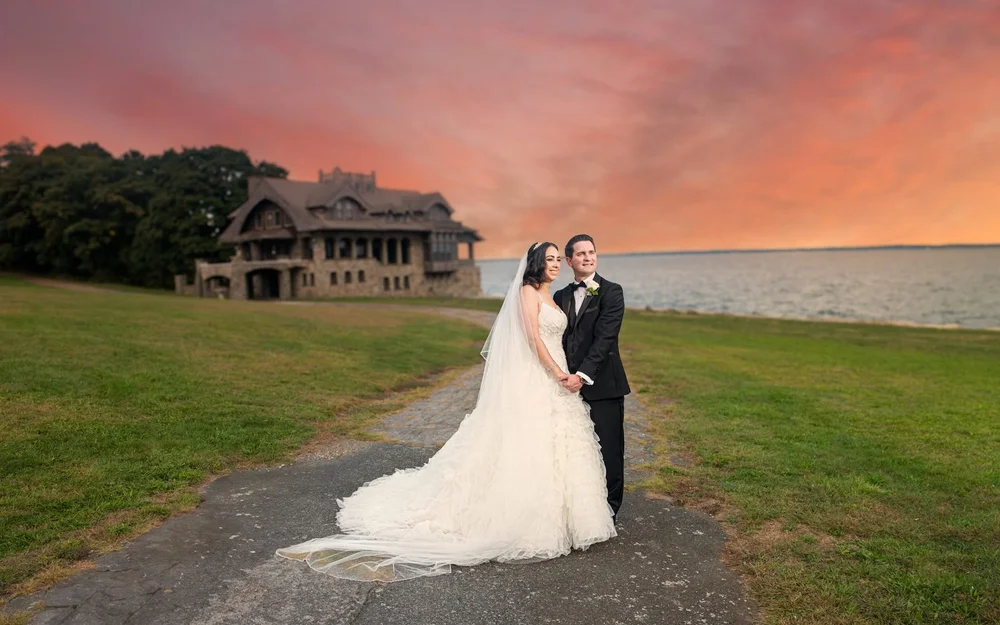 Aldrich Mansion wedding photographer, Warwick, RI — sunset portrait on the waterfront path with Narragansett Bay and the historic stone house behind