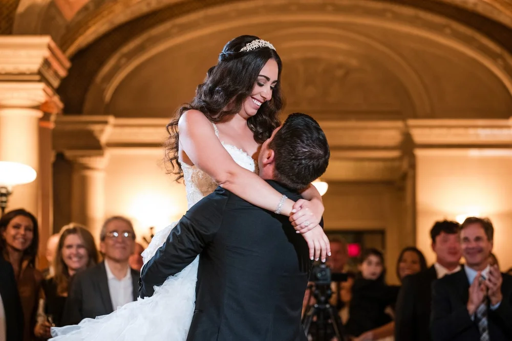 Aldrich Mansion wedding videographer, Warwick, RI — groom lifting the bride during their first dance beneath the vaulted plaster ceiling