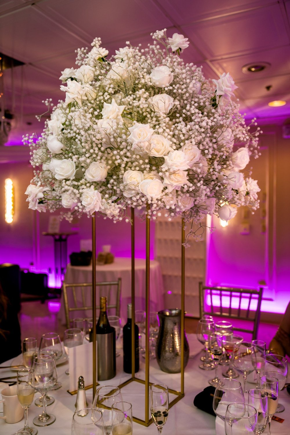 Anthony's Ocean View wedding photographer, New Haven, CT — tall white rose and baby's breath ballroom centerpiece with reception uplighting