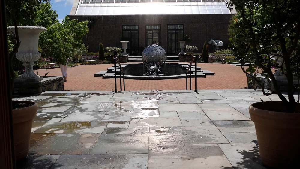 Entry courtyard with reflecting pool and stone patio at Tower Hill Botanic Garden wedding venue in Boylston, MA