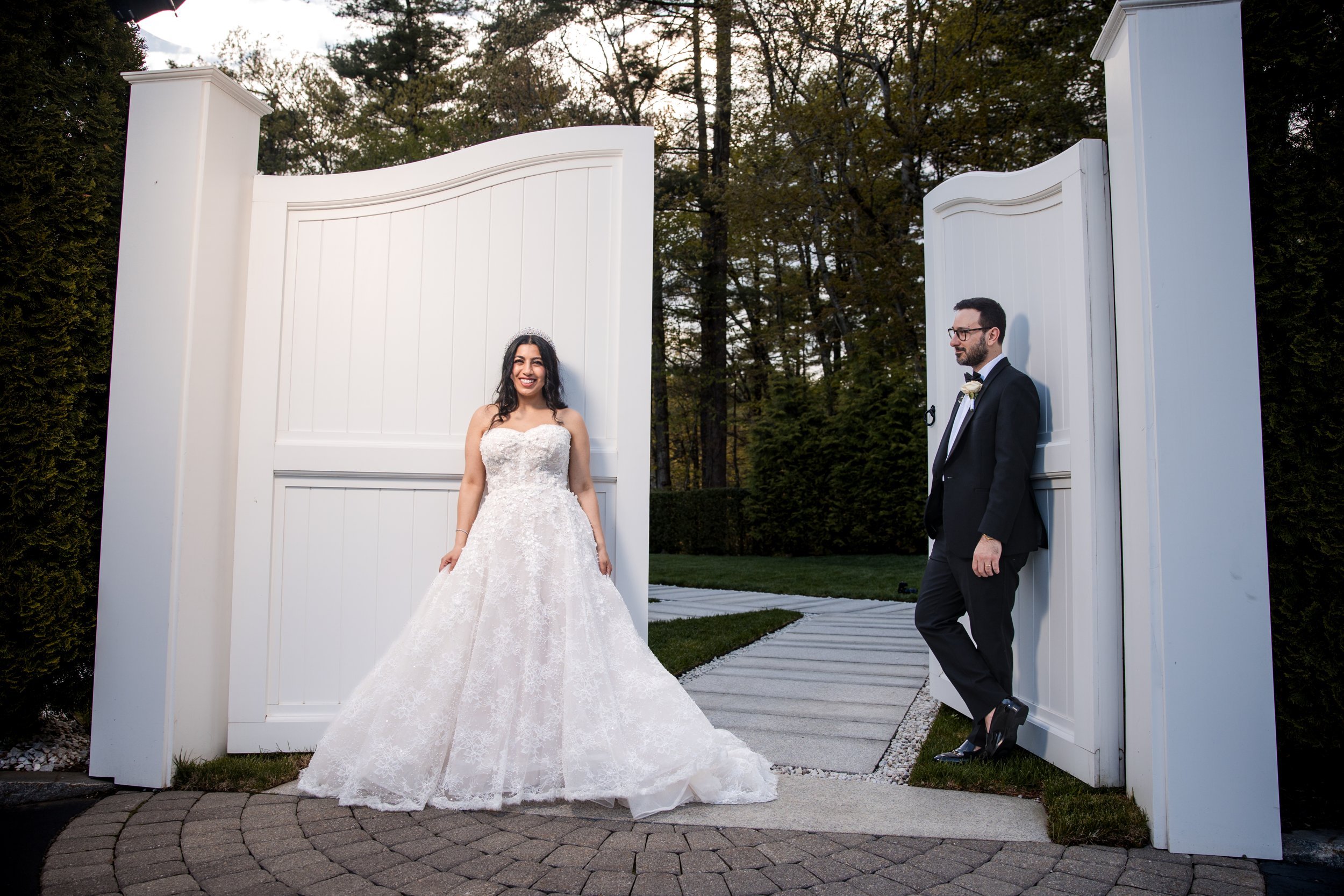 Couple in front of the white courtyard gate at Lakeview Pavilion, Foxborough, Massachusetts