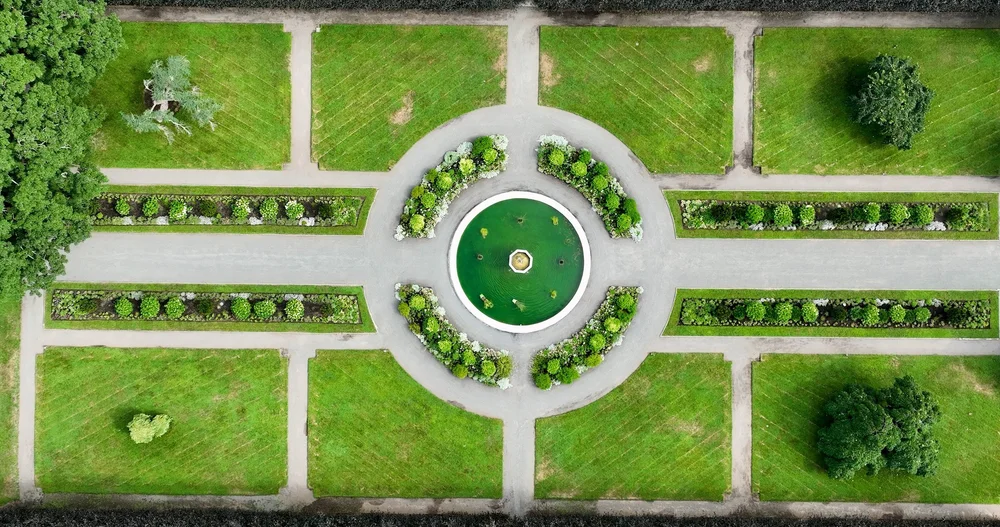 The Gardens at Elm Bank wedding videographer, Wellesley, MA — aerial drone view of the Italianate Garden fountain and symmetrical lawns
