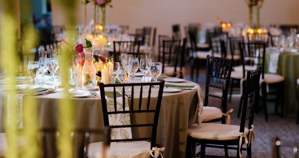 The Gardens at Elm Bank wedding photographer, Wellesley, MA — Hunnewell Building reception tables with candlelight, florals, and black Chiavari chairs