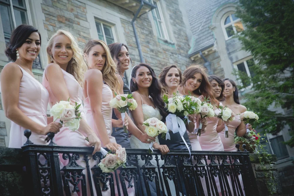 Aldrich Mansion wedding photographer, Warwick, RI — bride and bridesmaids with white rose bouquets along the wrought-iron balcony