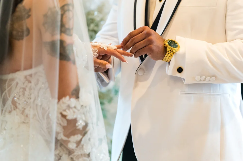 Anthony's Ocean View wedding videographer, New Haven, CT — groom placing the wedding ring on the bride's finger during the ceremony