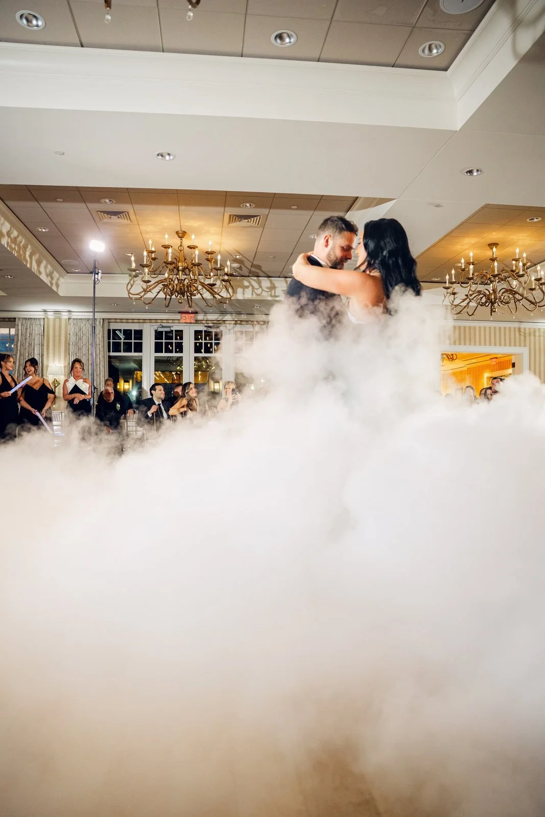 Beauport Hotel wedding photographer, Gloucester, MA — first dance on a cloud of low fog beneath the ballroom chandeliers
