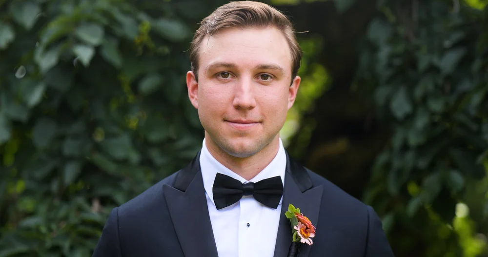 The Gardens at Elm Bank wedding photographer, Wellesley, MA — groom portrait in a black bow tie and tuxedo in the gardens