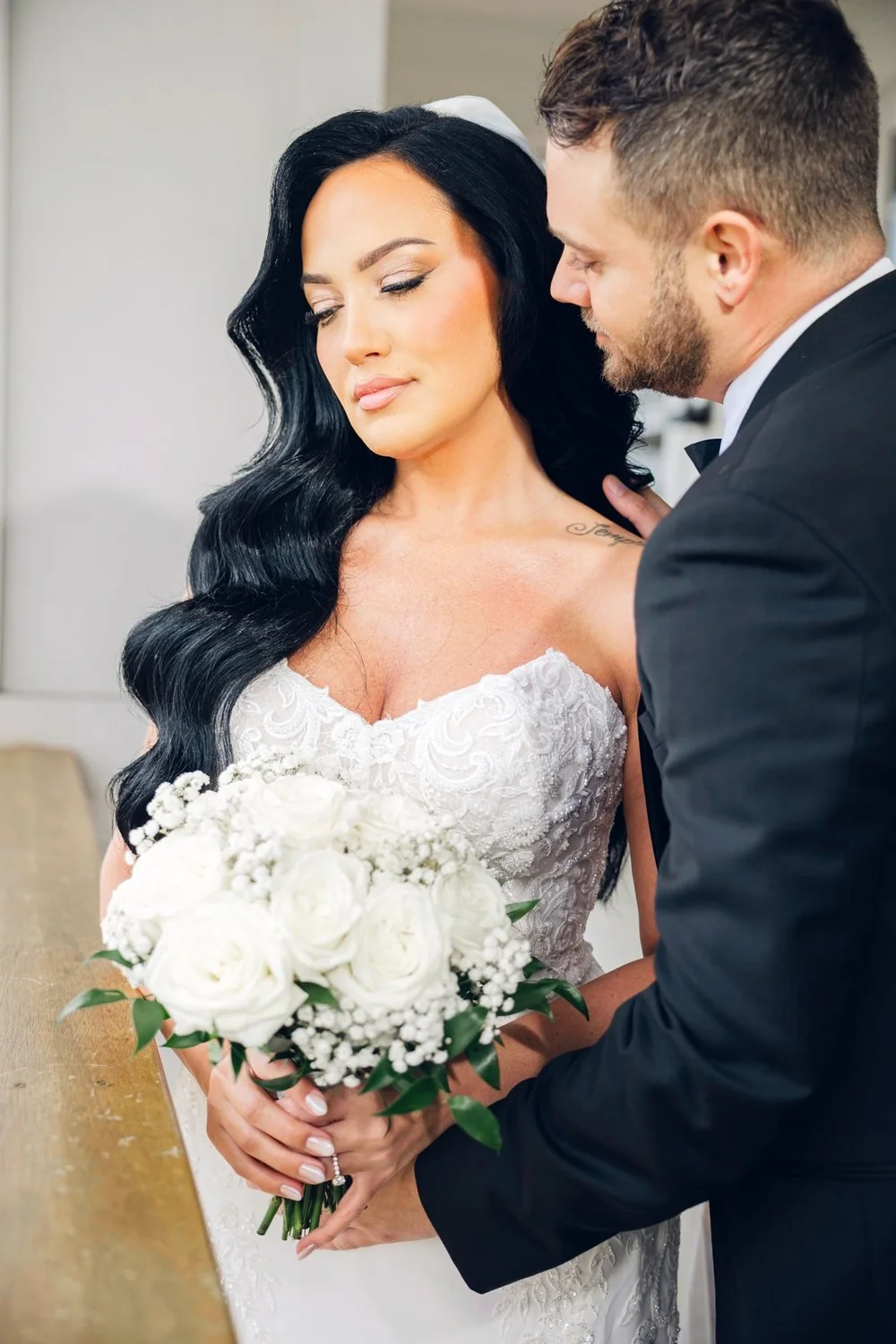 Beauport Hotel wedding videographer, Gloucester, MA — bride and groom close together on the harborfront deck