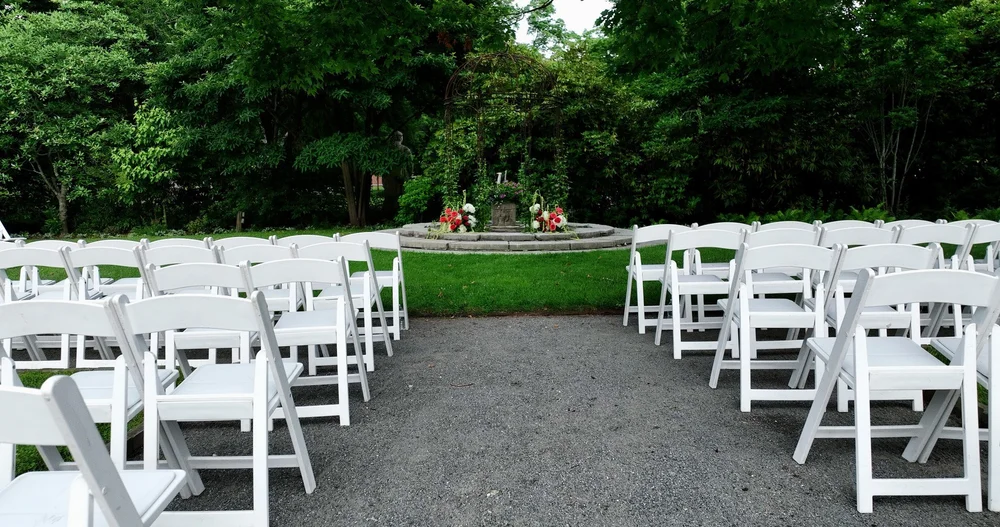 The Gardens at Elm Bank wedding photographer, Wellesley, MA — outdoor garden ceremony chairs and floral wrought-iron pergola