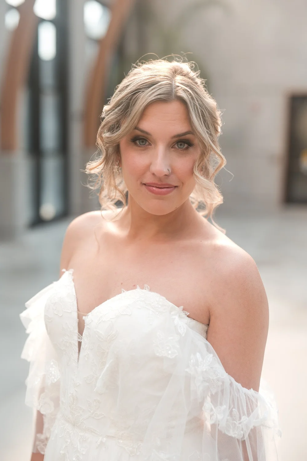 Backlit bridal portrait in an off-the-shoulder lace gown inside the conservatory at New England Botanic Garden at Tower Hill, Boylston, MA