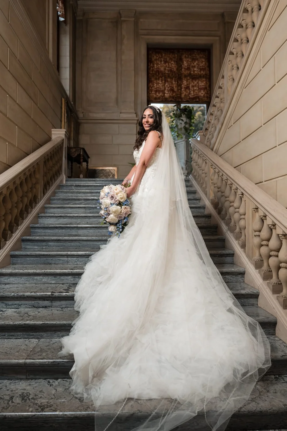 Aldrich Mansion wedding photographer, Warwick, RI — bridal portrait with cascading bouquet and cathedral train on the grand marble staircase