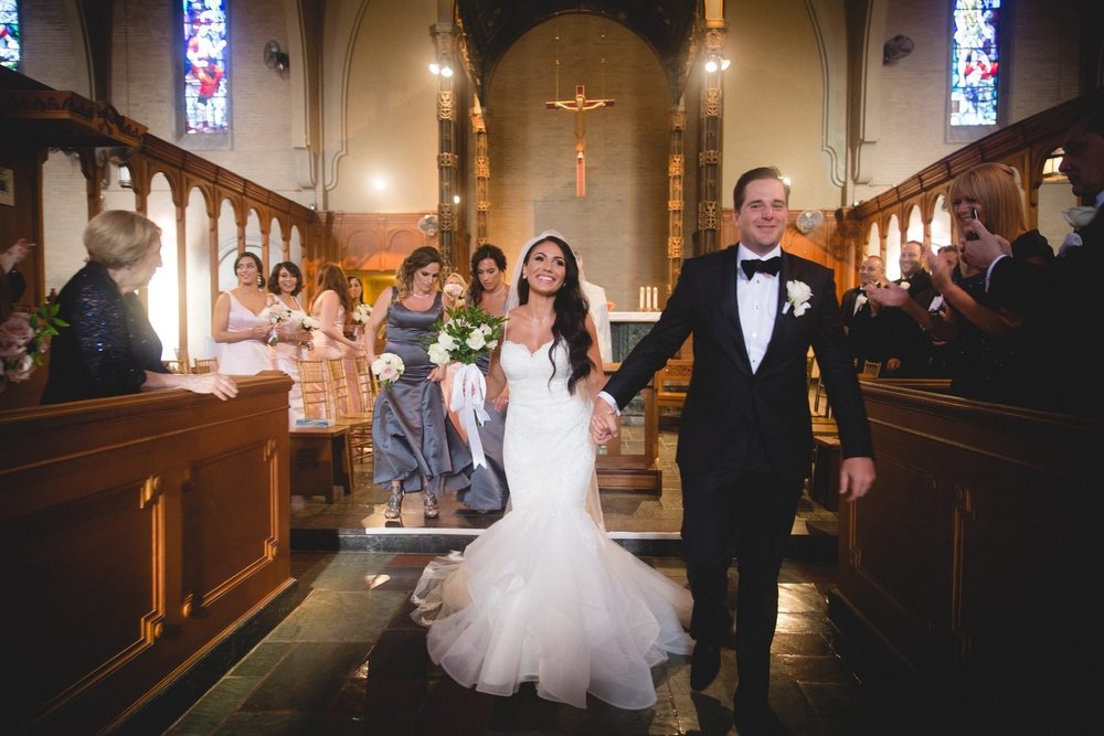 Aldrich Mansion wedding videographer, Warwick, RI — joyful recessional down the center aisle of Our Lady of Providence Chapel