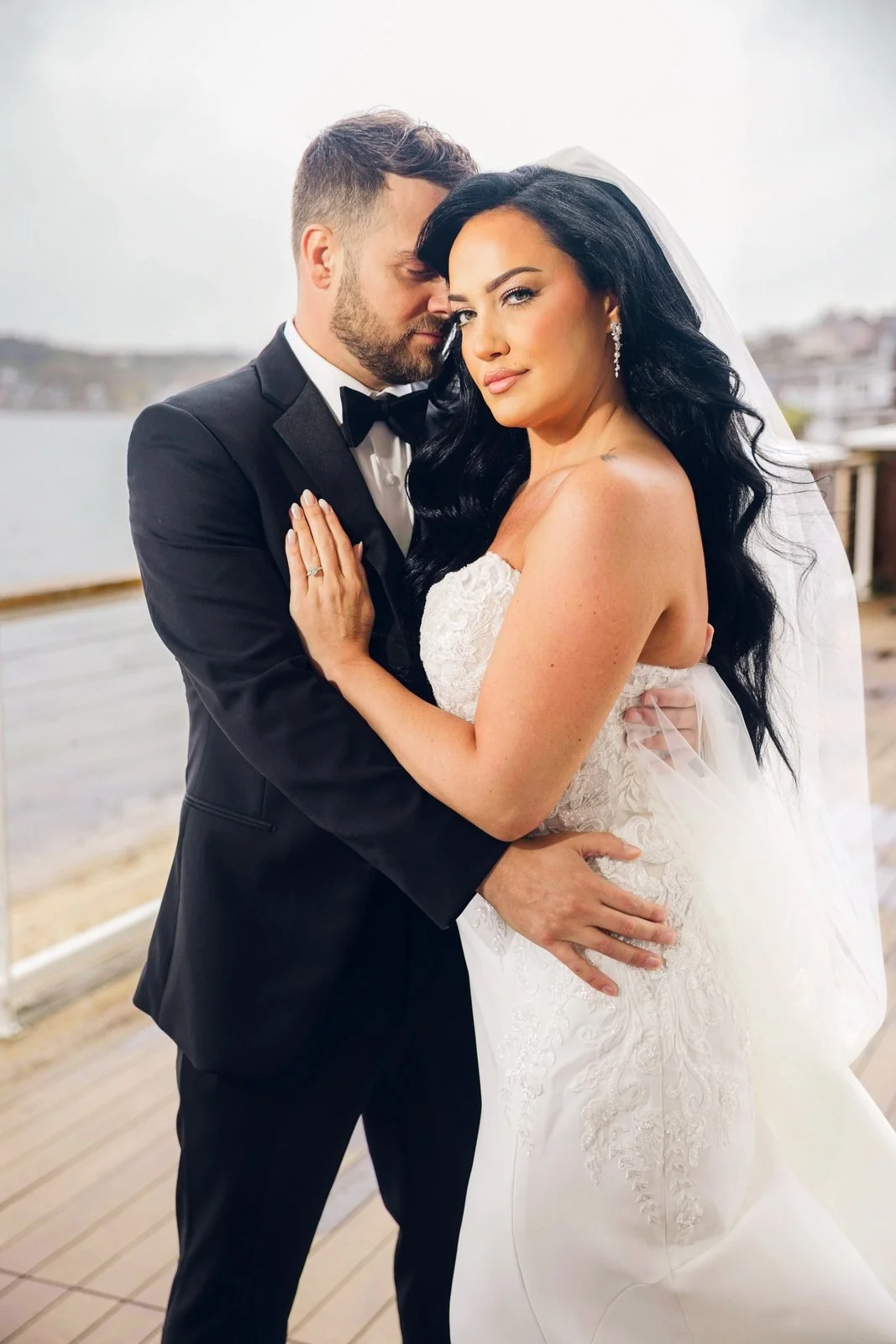 Beauport Hotel wedding photographer, Gloucester, MA — groom holding the bride on the oceanfront deck above the harbor