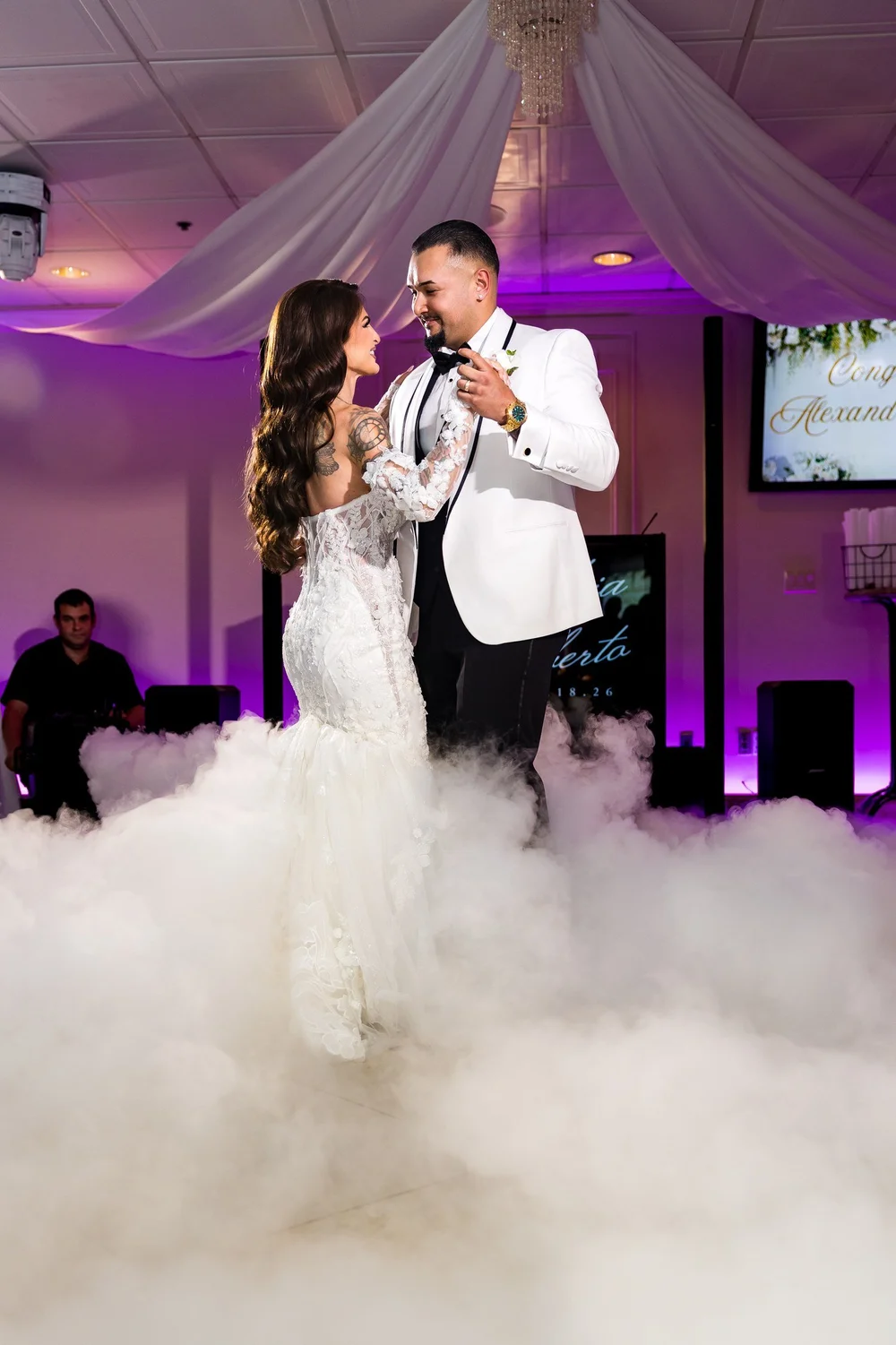 Anthony's Ocean View wedding videographer, New Haven, CT — bride and groom first dance on the clouds under the ballroom chandelier