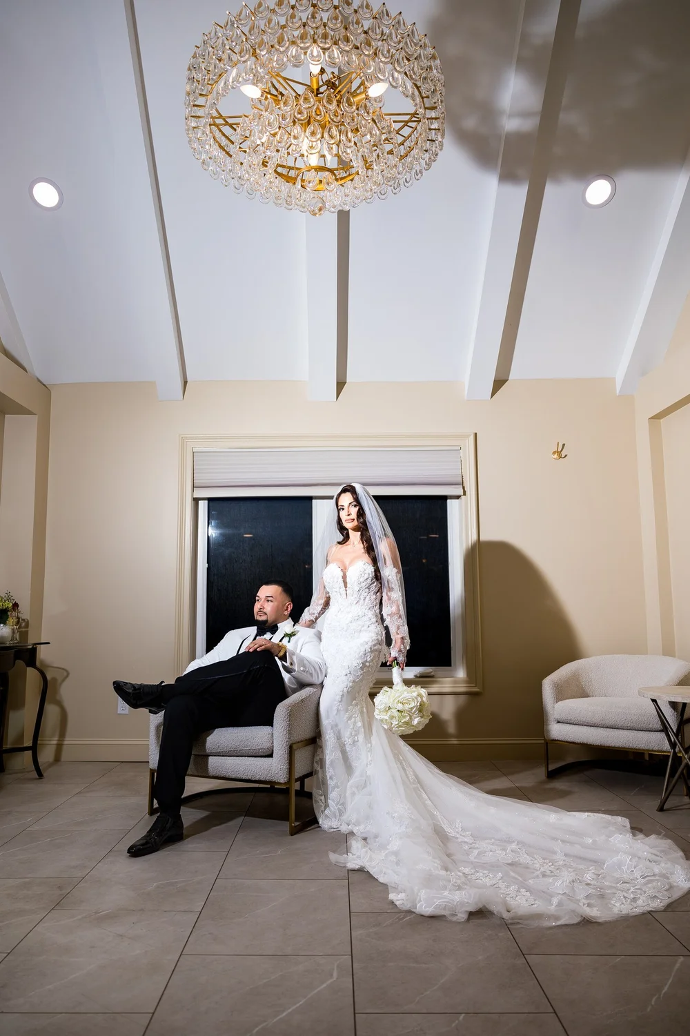 Anthony's Ocean View wedding photographer, New Haven, CT — bride and groom portrait beneath the crystal chandelier in the bridal suite