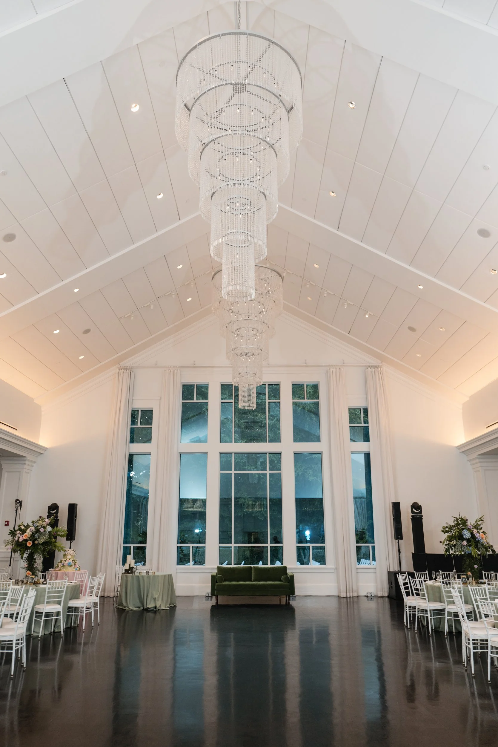 Cathedral ceiling, tiered crystal chandelier and floor-to-ceiling windows in a Lakeview Pavilion ballroom, Foxborough, Massachusetts