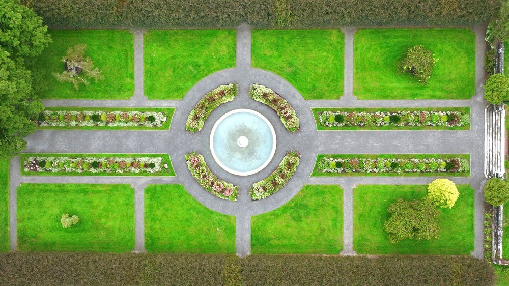 The Gardens at Elm Bank wedding videographer, Wellesley, MA — top-down aerial view of the formal garden parterre and stone steps