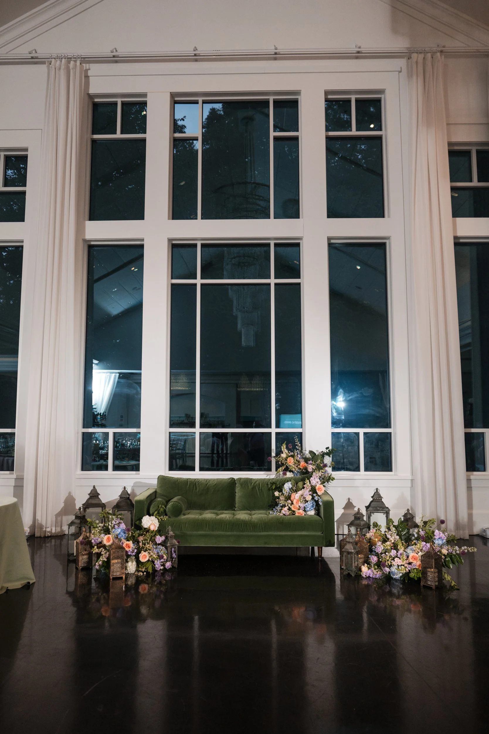 Velvet lounge and florals before the ballroom windows at Lakeview Pavilion, Foxborough, Massachusetts