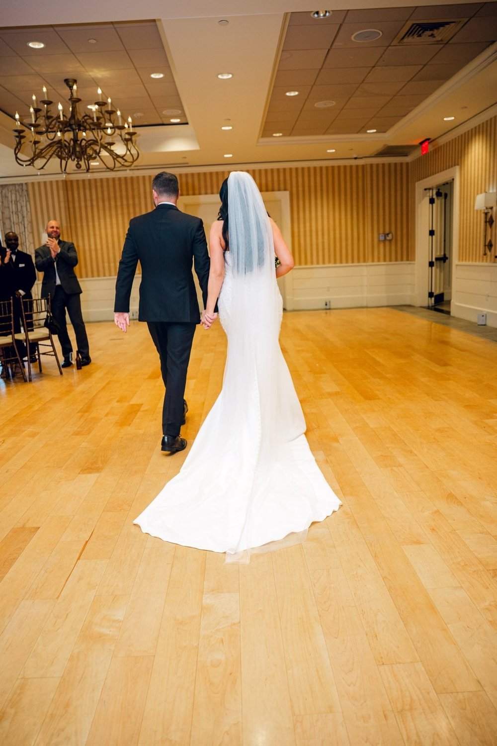 Beauport Hotel wedding photographer, Gloucester, MA — bride and groom walking the hardwood aisle of the Oceanside Grand Ballroom