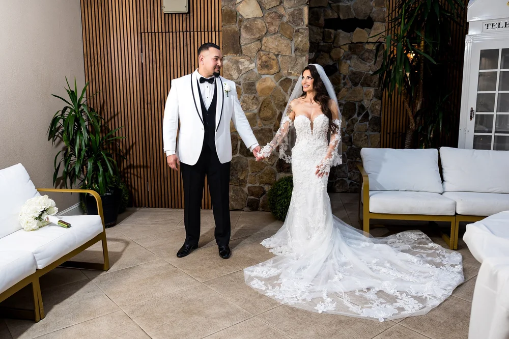 Anthony's Ocean View wedding photographer, New Haven, CT — bride and groom holding hands inside the stone and wood lounge