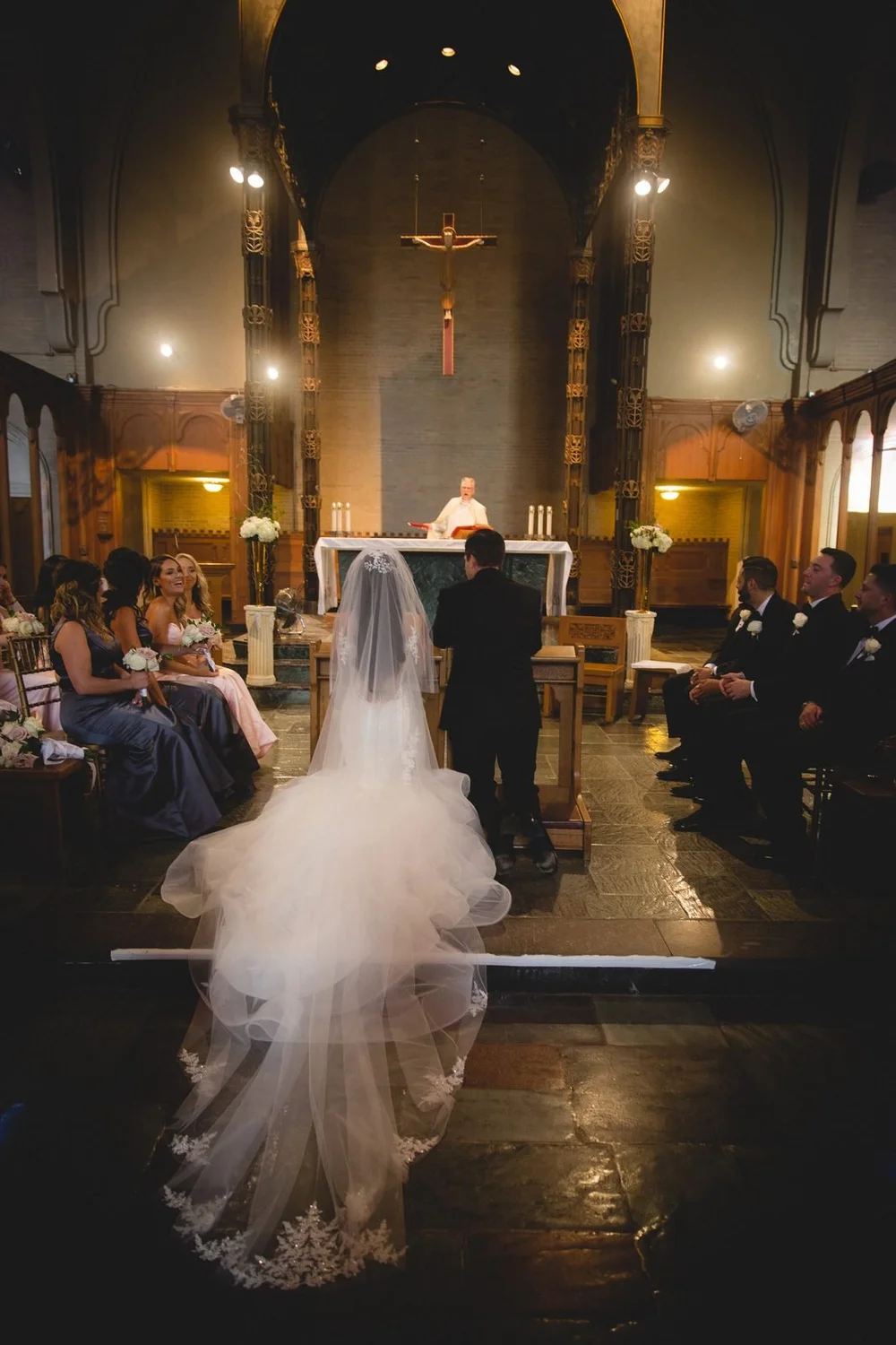 Aldrich Mansion wedding photographer, Warwick, RI — bride and groom at the altar inside Our Lady of Providence Chapel