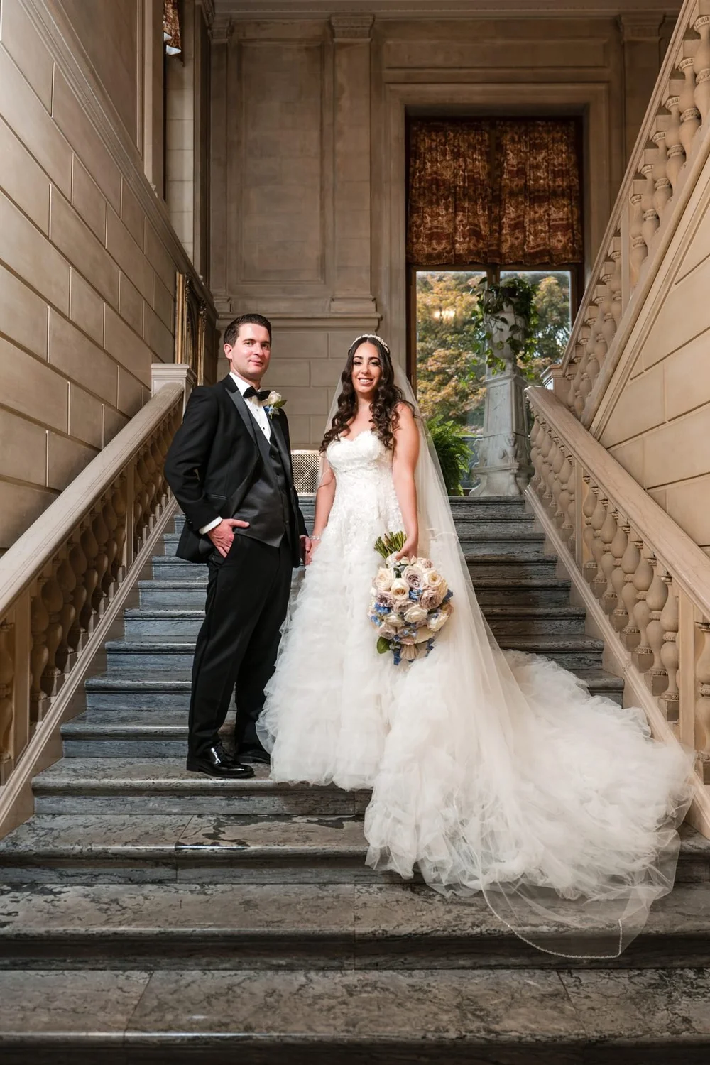 Aldrich Mansion wedding videographer, Warwick, RI — bride and groom portrait on the grand marble staircase of Aldrich Mansion