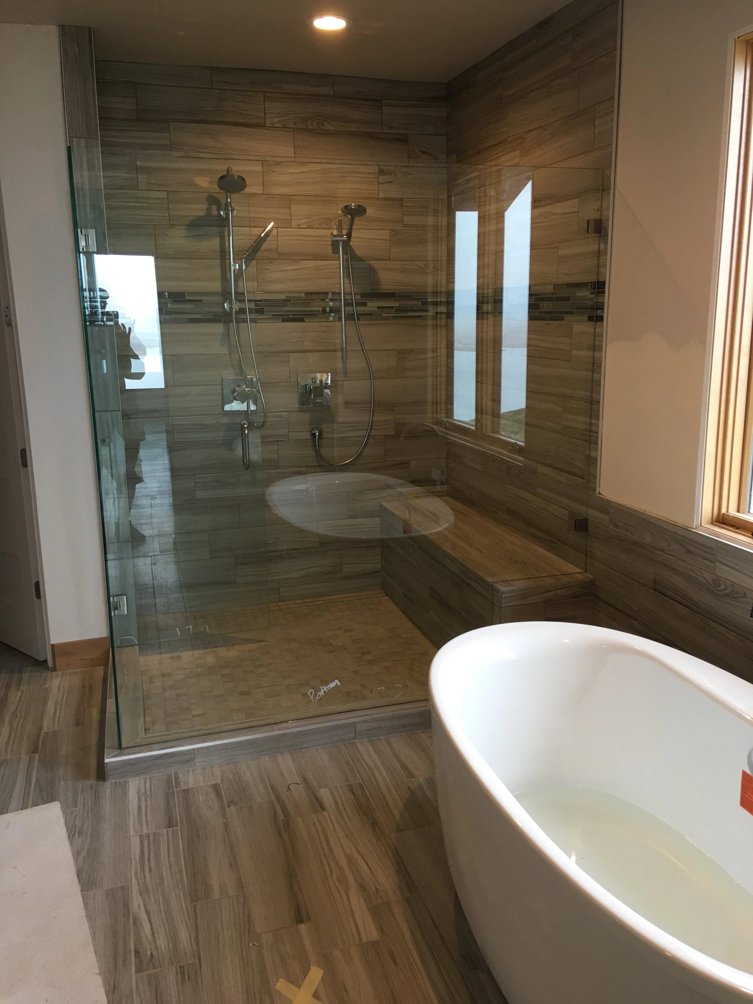Spa bathroom with walk-in glass shower and freestanding soaking tub