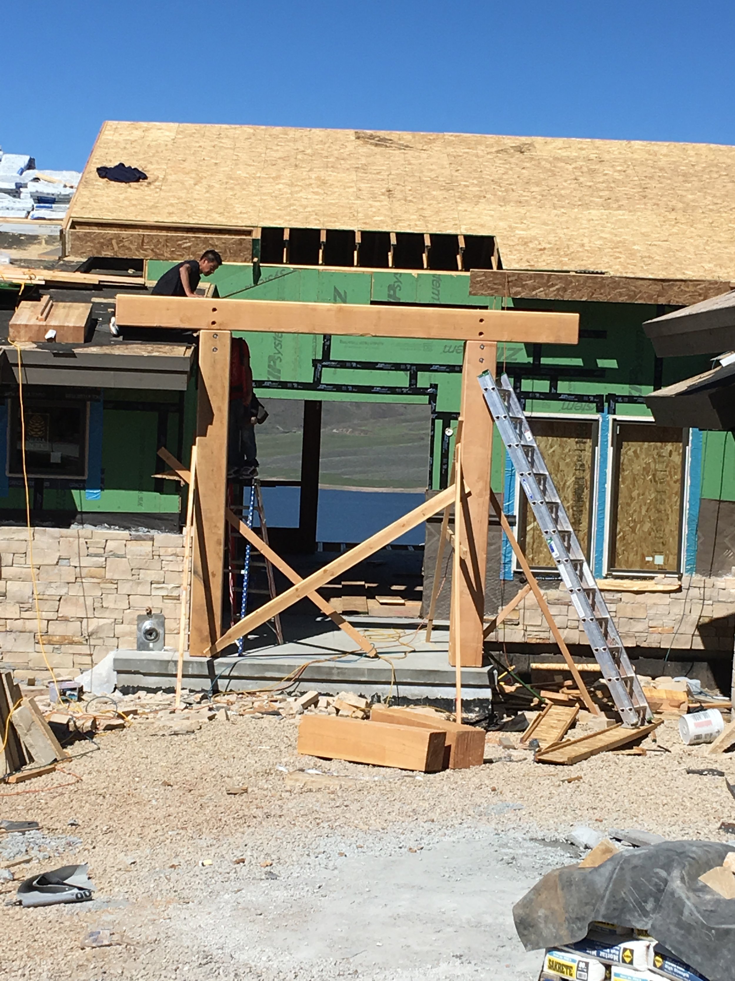 Timber entry porch framing with stone base