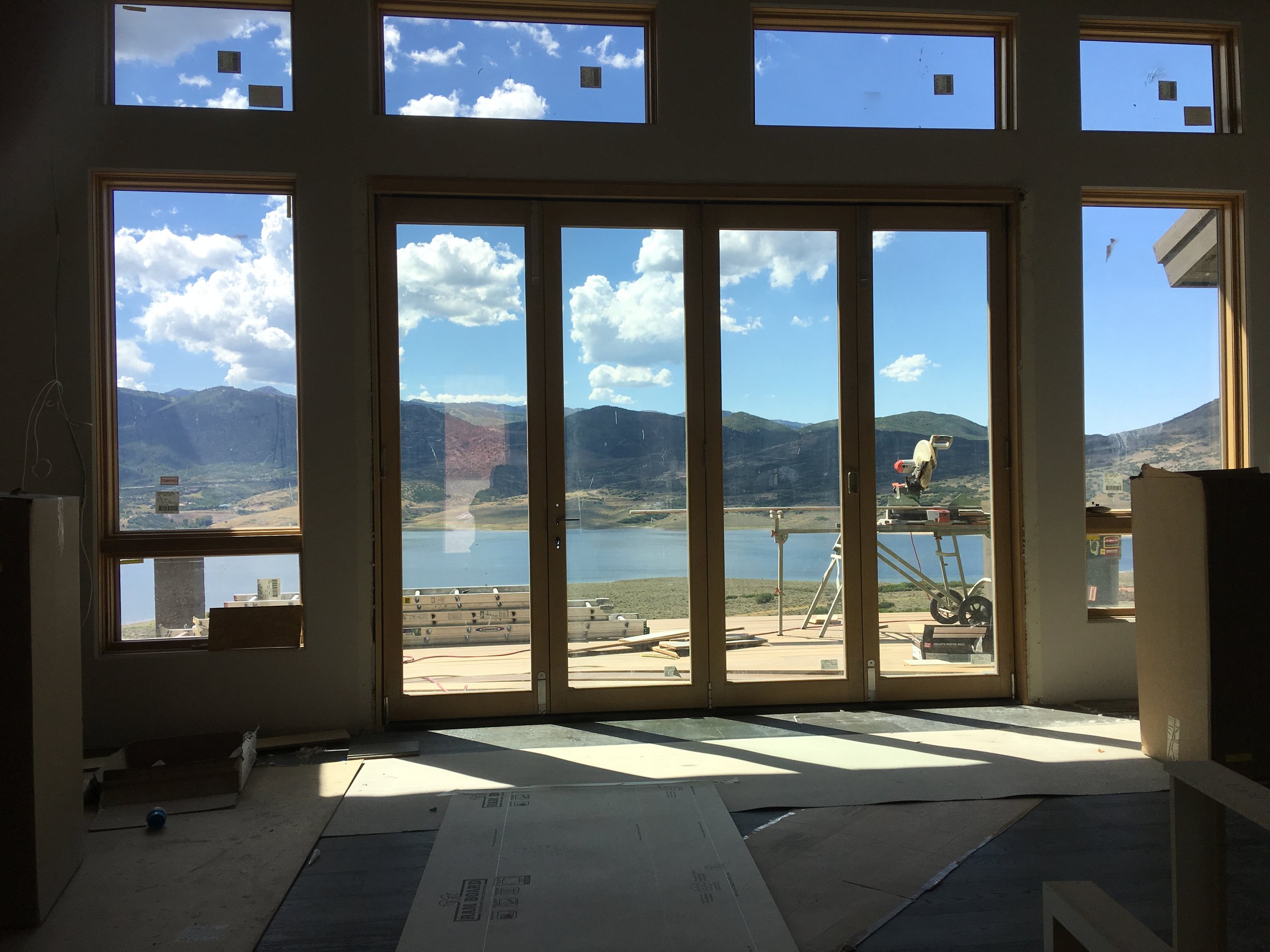 Folding glass doors and transom windows with lake and mountain view