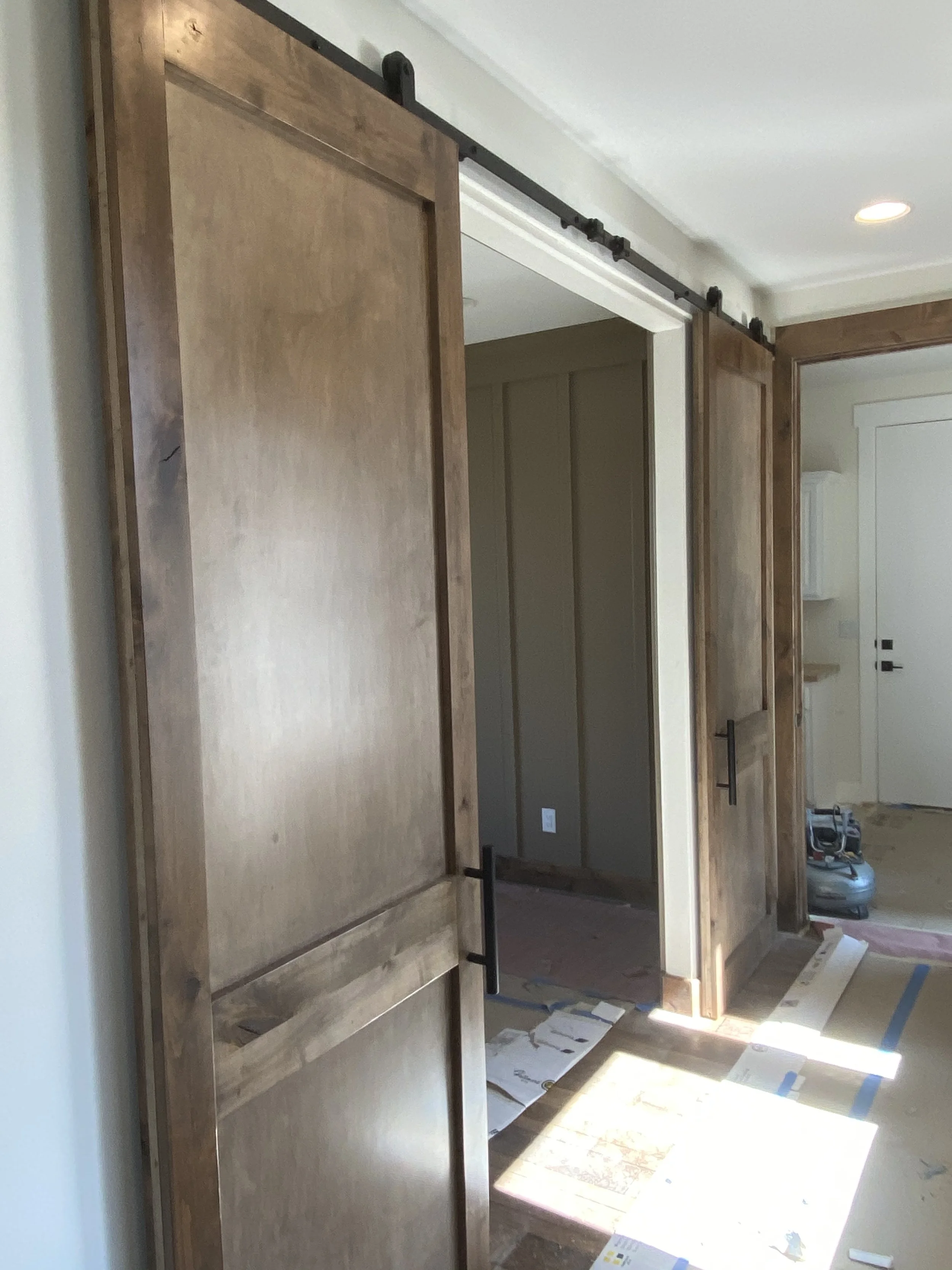 Custom wood sliding barn doors on black hardware