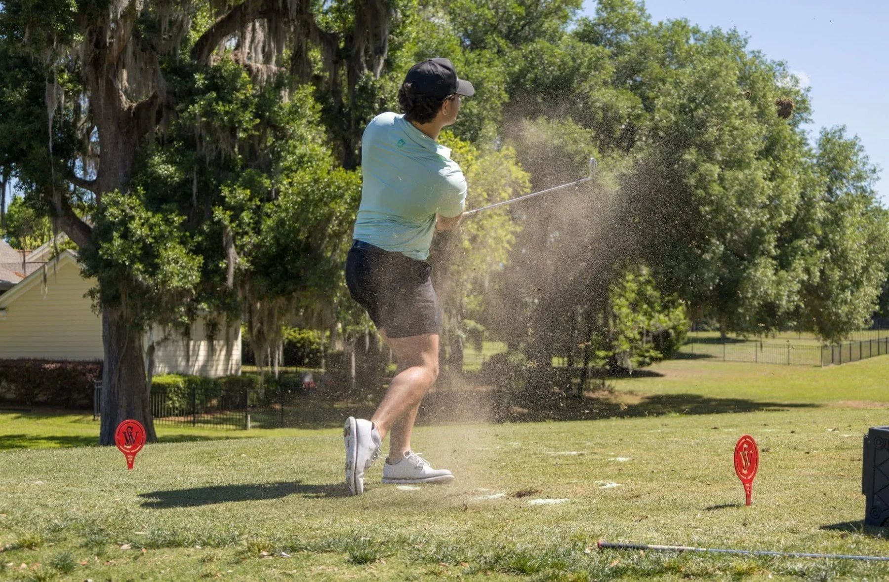 A golfer tees off