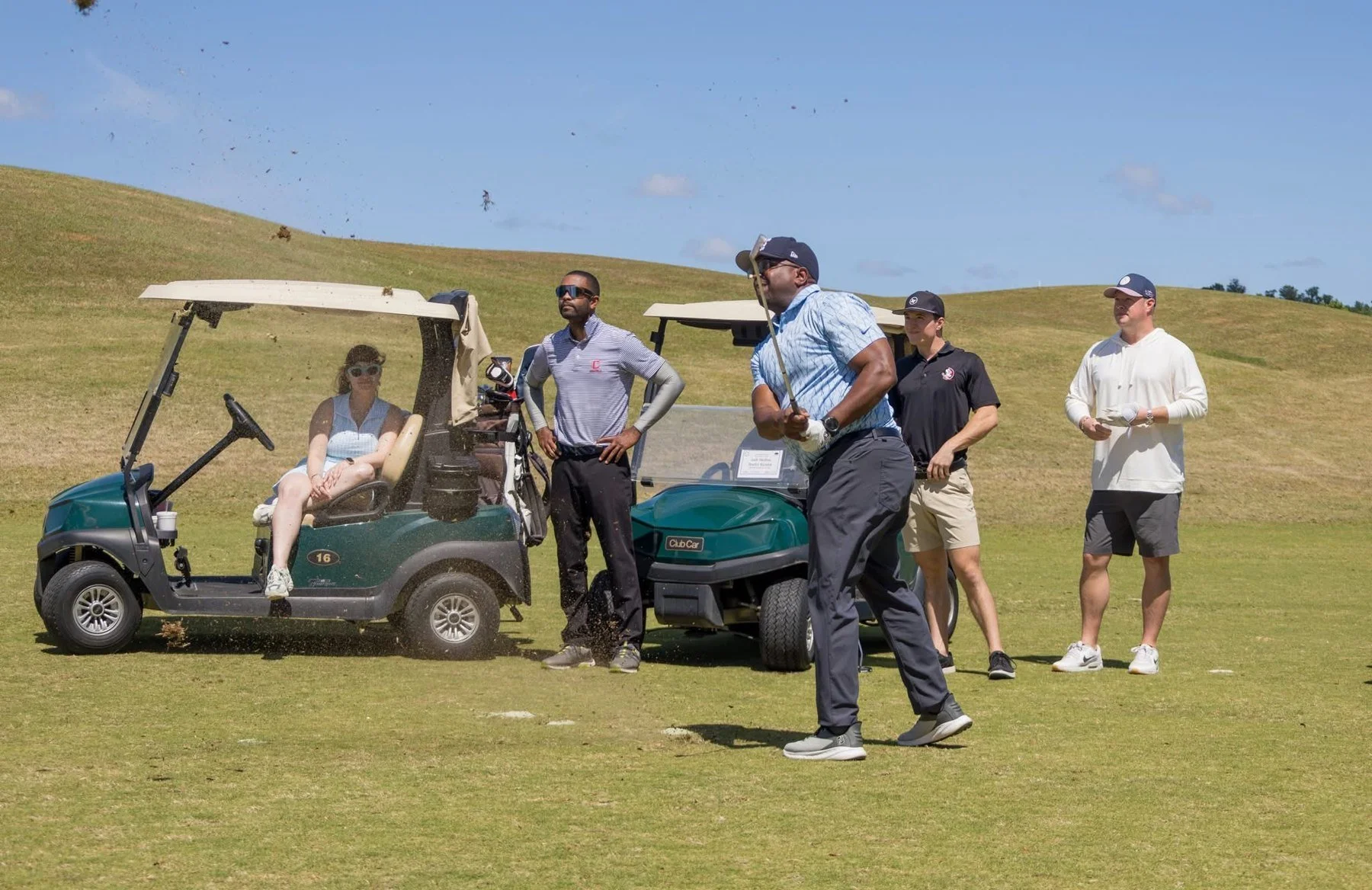 Teams watching a tee shot