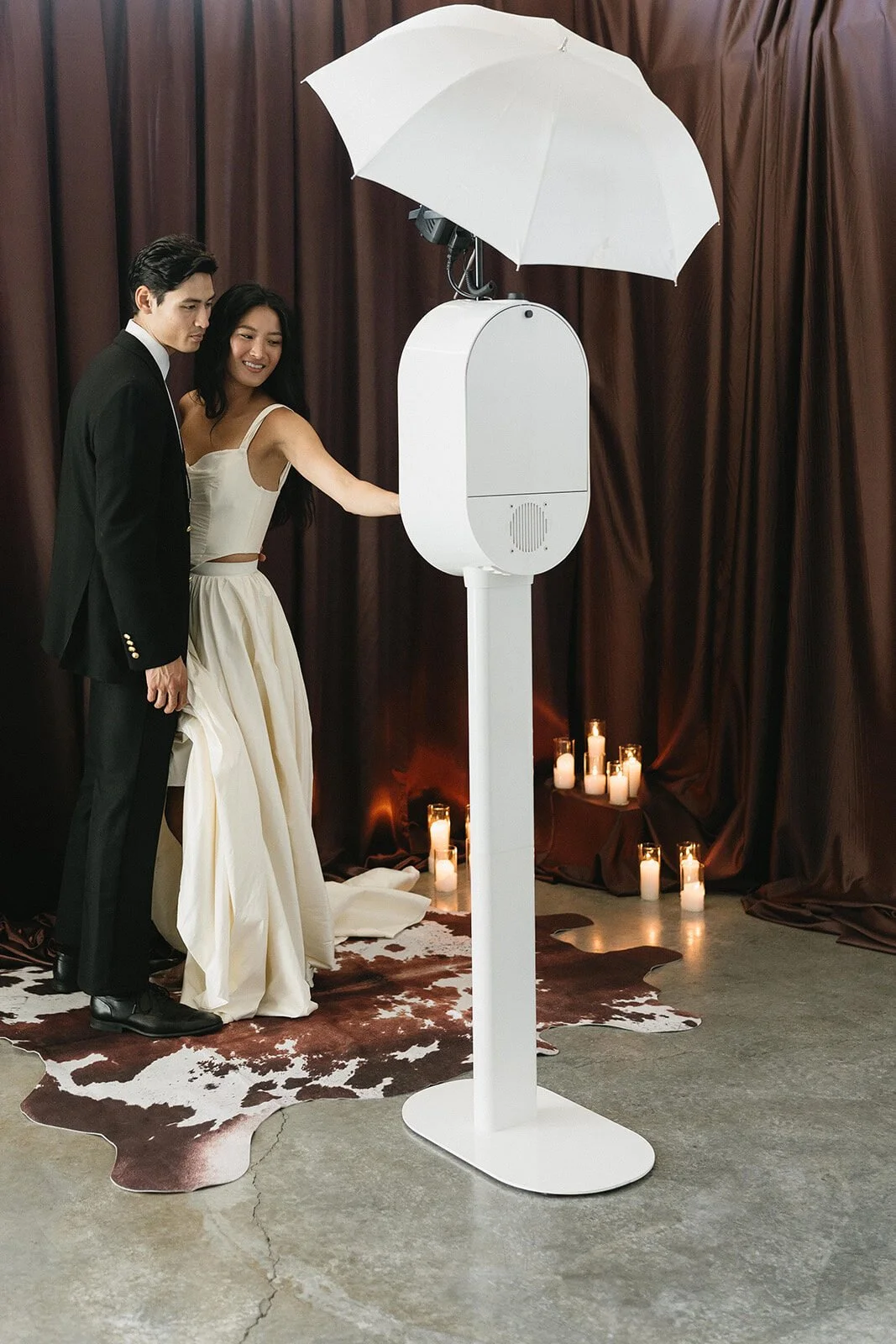 Bride and groom sharing a candlelit moment at the Wuddabooth photo booth