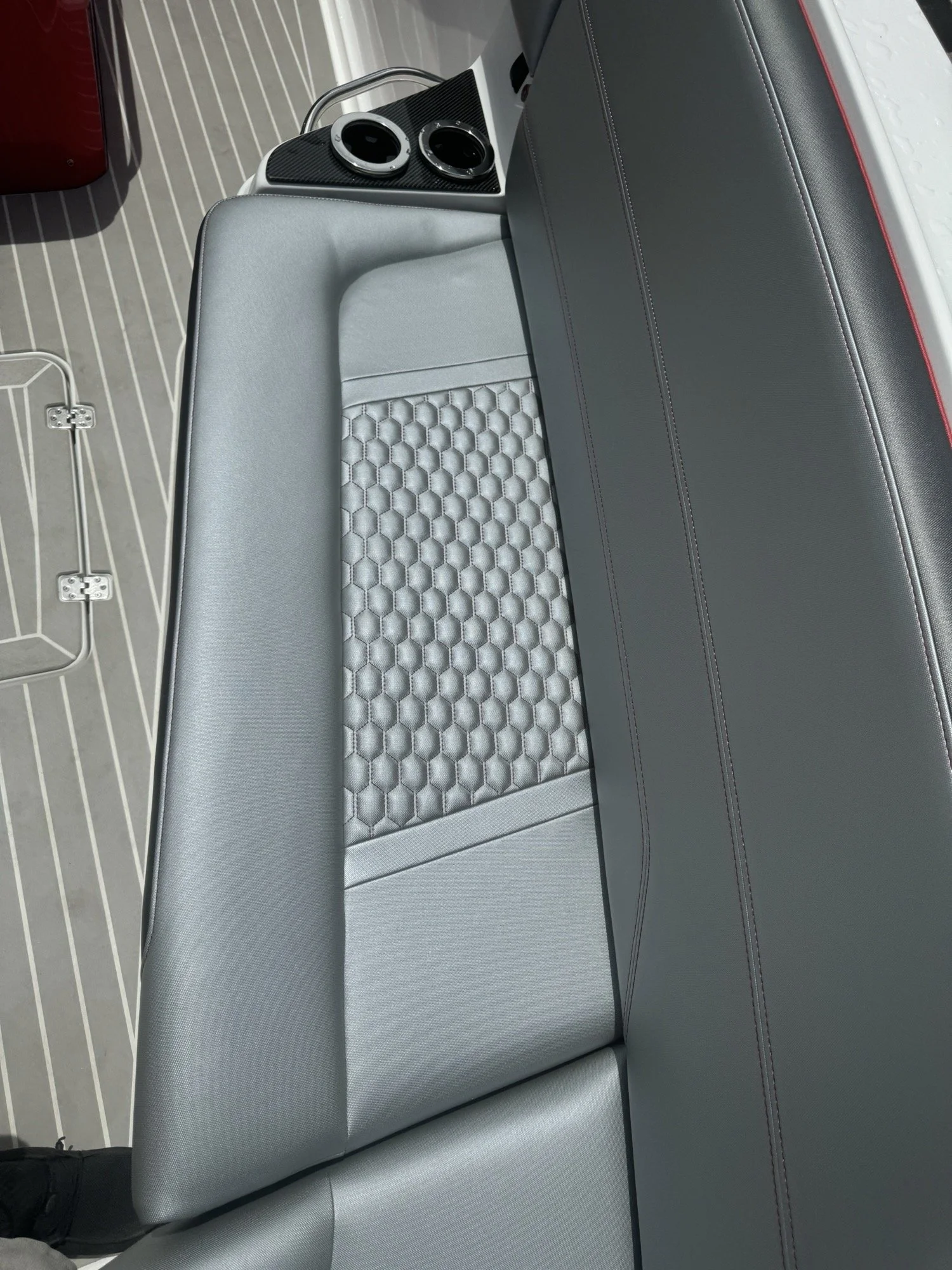 Close detail of grey hexagon-quilted marine vinyl stitching on a finished boat seat