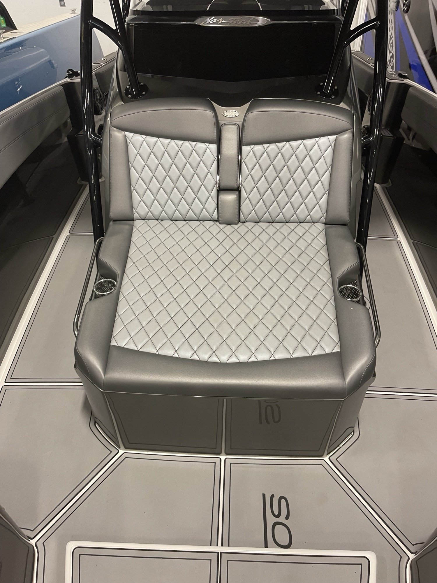 Nor-Tech aft lounge seat in silver diamond-stitch vinyl over charcoal bolsters, with matching grey EVA flooring, built by Rivers Refined in Oakland Park