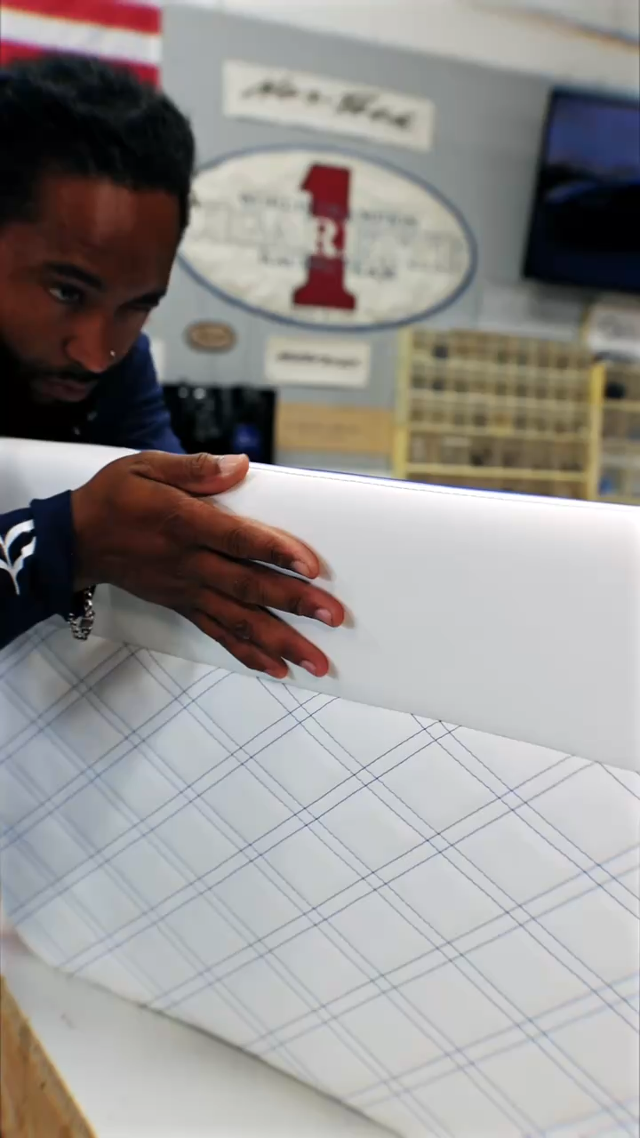 Shaun Rivers in the Rivers Refined shop in Oakland Park, holding a marked-out interior panel