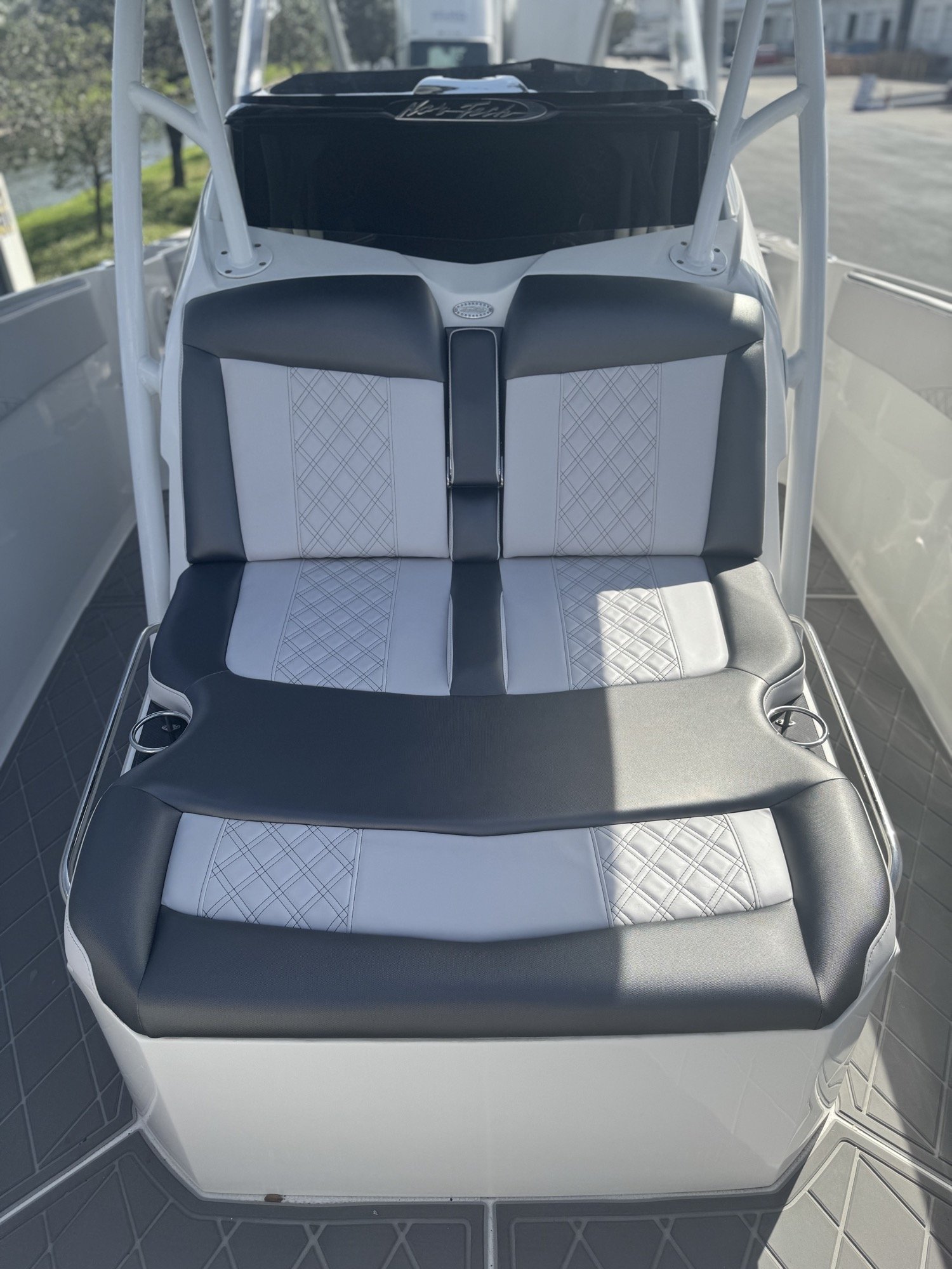 Nor-Tech helm bench and forward seating in white and grey diamond-stitch vinyl with charcoal trim and matching diamond EVA flooring