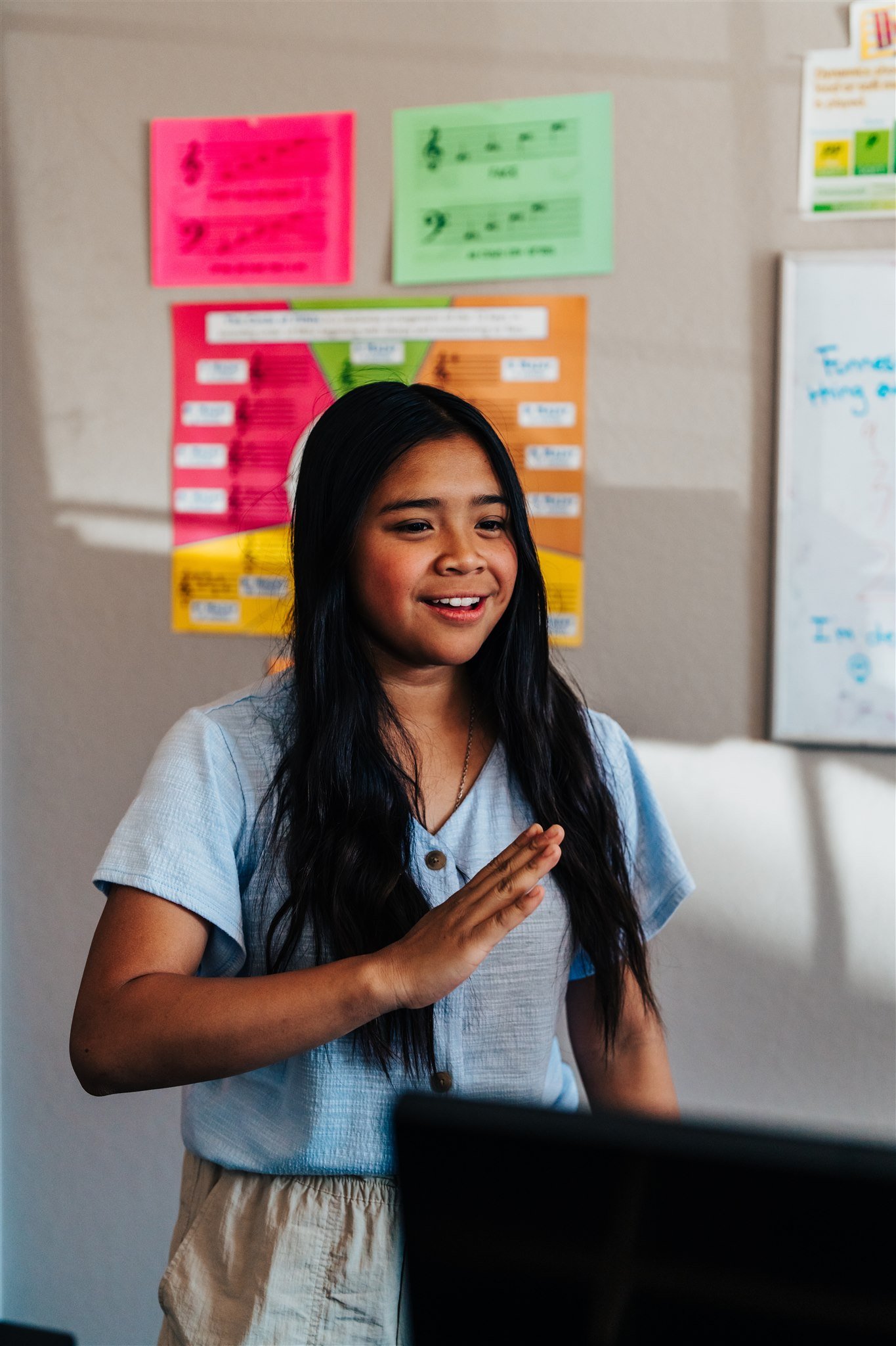 A teenage voice student singing expressively during a lesson