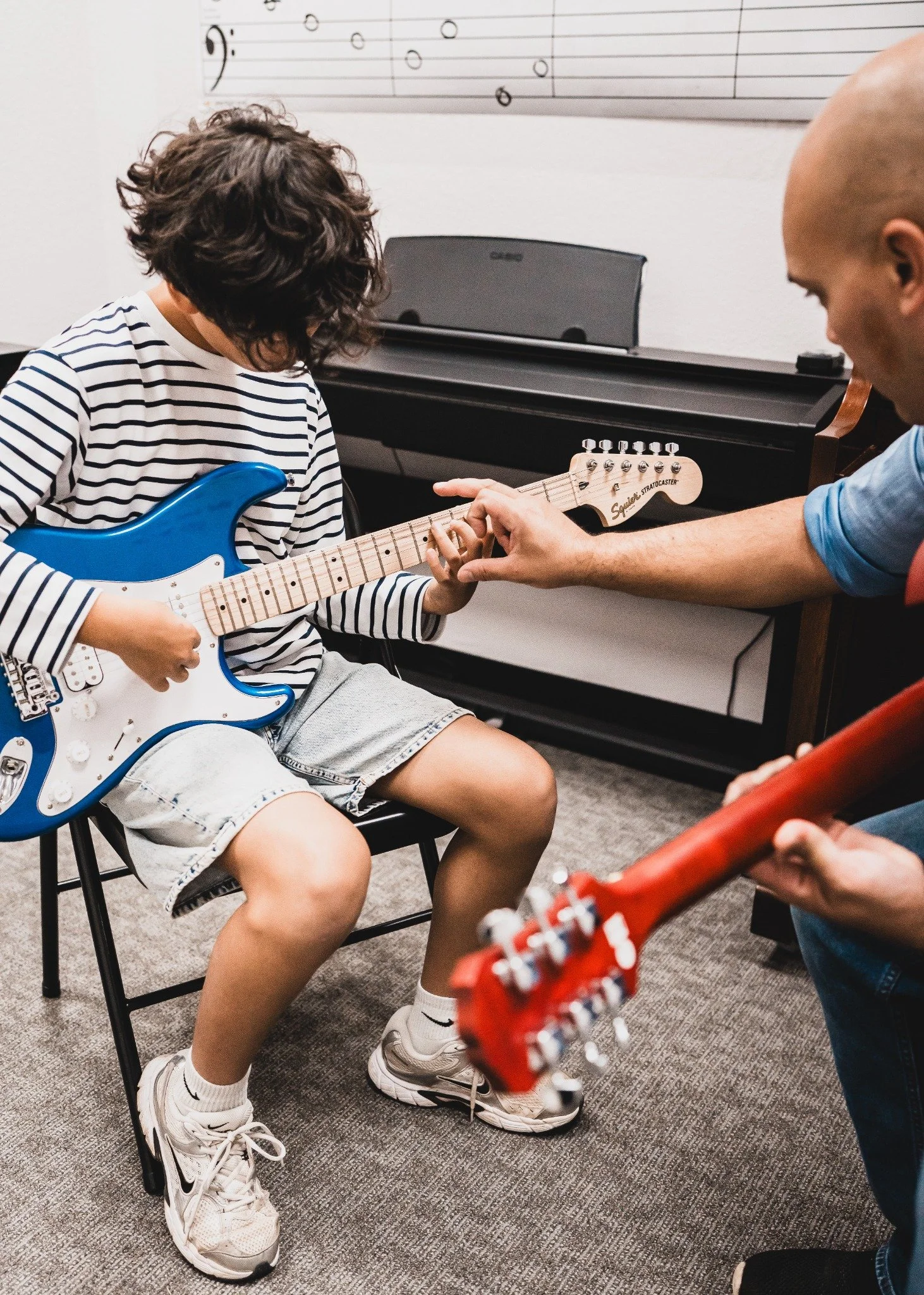 Teacher and student playing electric guitars in a private lesson