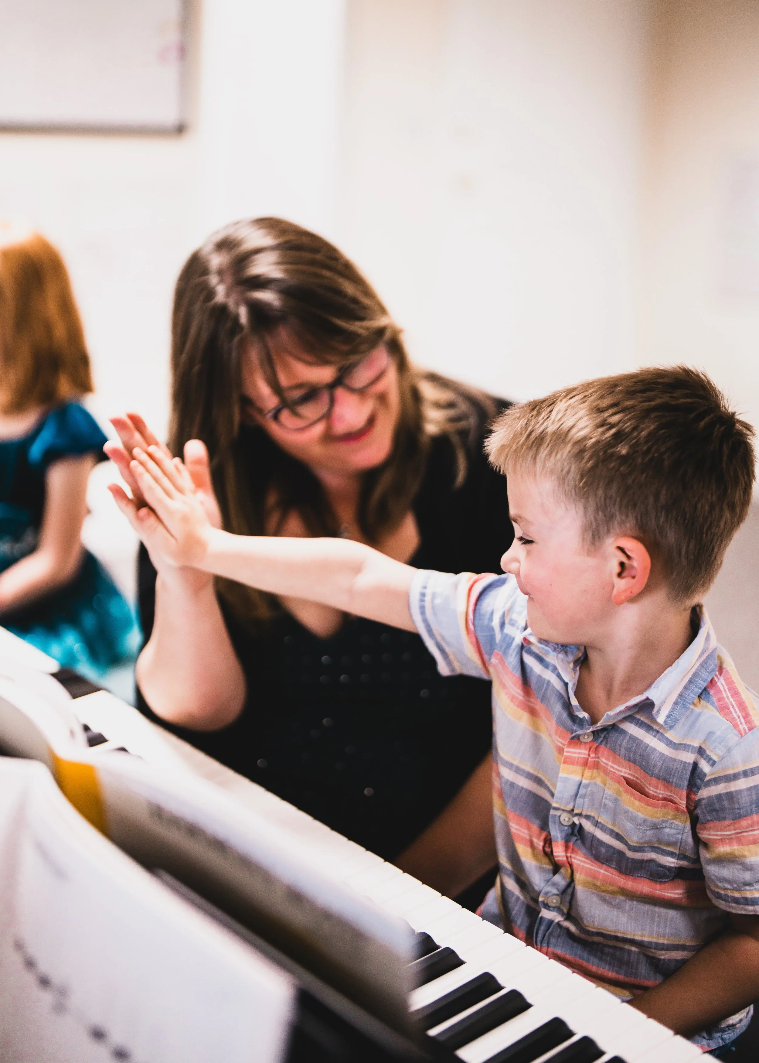 A Heart Beats teacher working with a young piano student