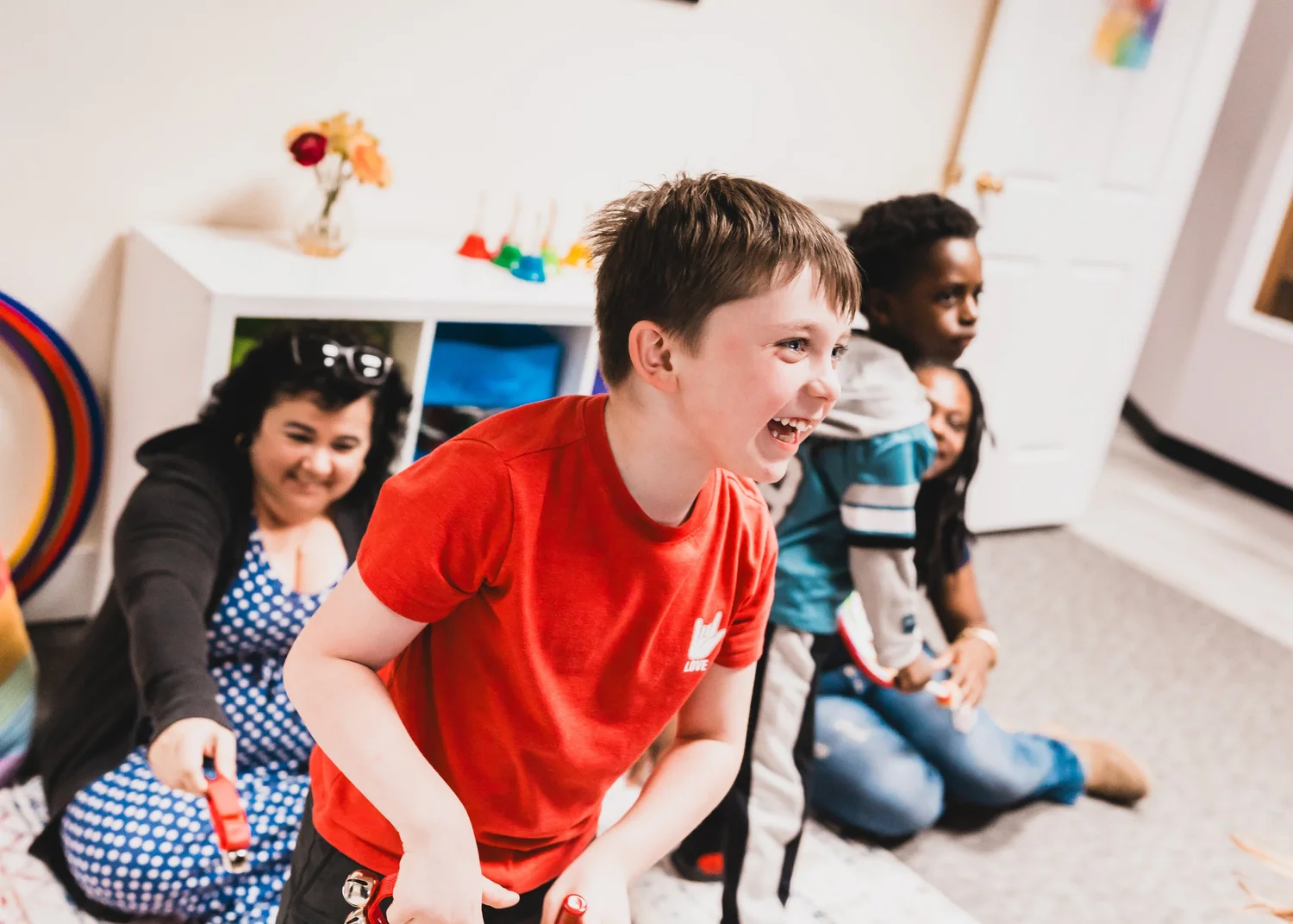 A child laughing during a Harmony Road music class at Heart Beats