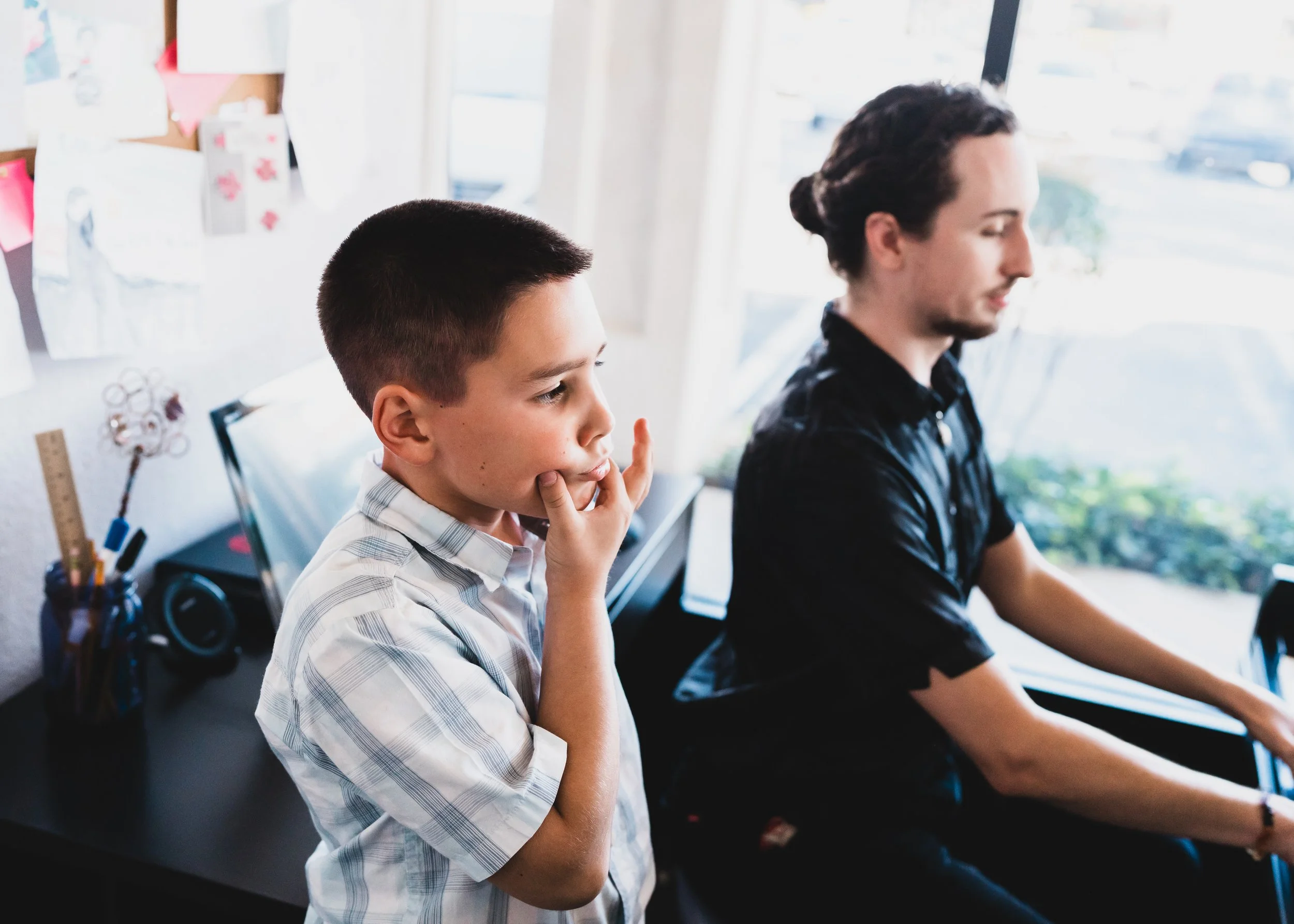 A young voice student practicing an exercise with Michael accompanying him at the piano