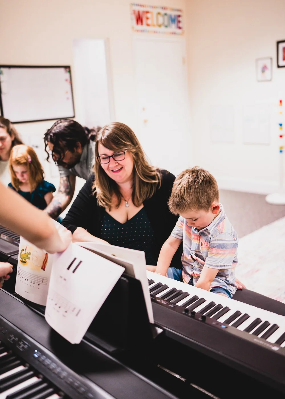 A child and grown-up learning together at a keyboard