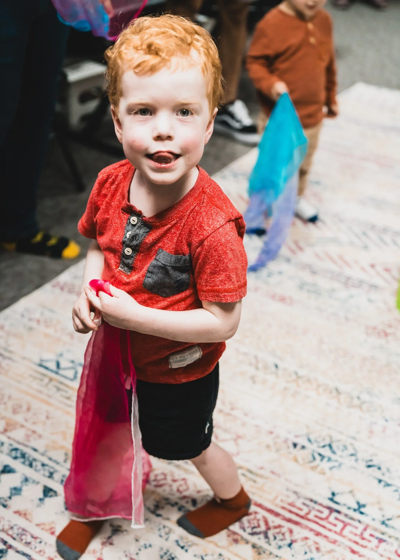 Young child participating in a scarf movement activity