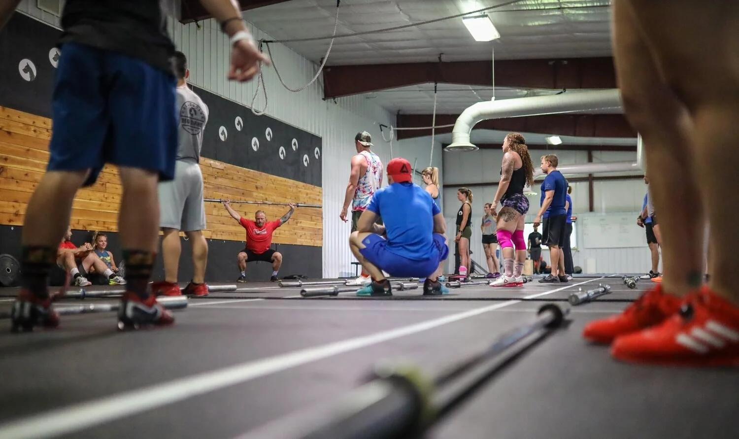 Lifters working through the Olympic lifts on platforms at CrossFit Excel