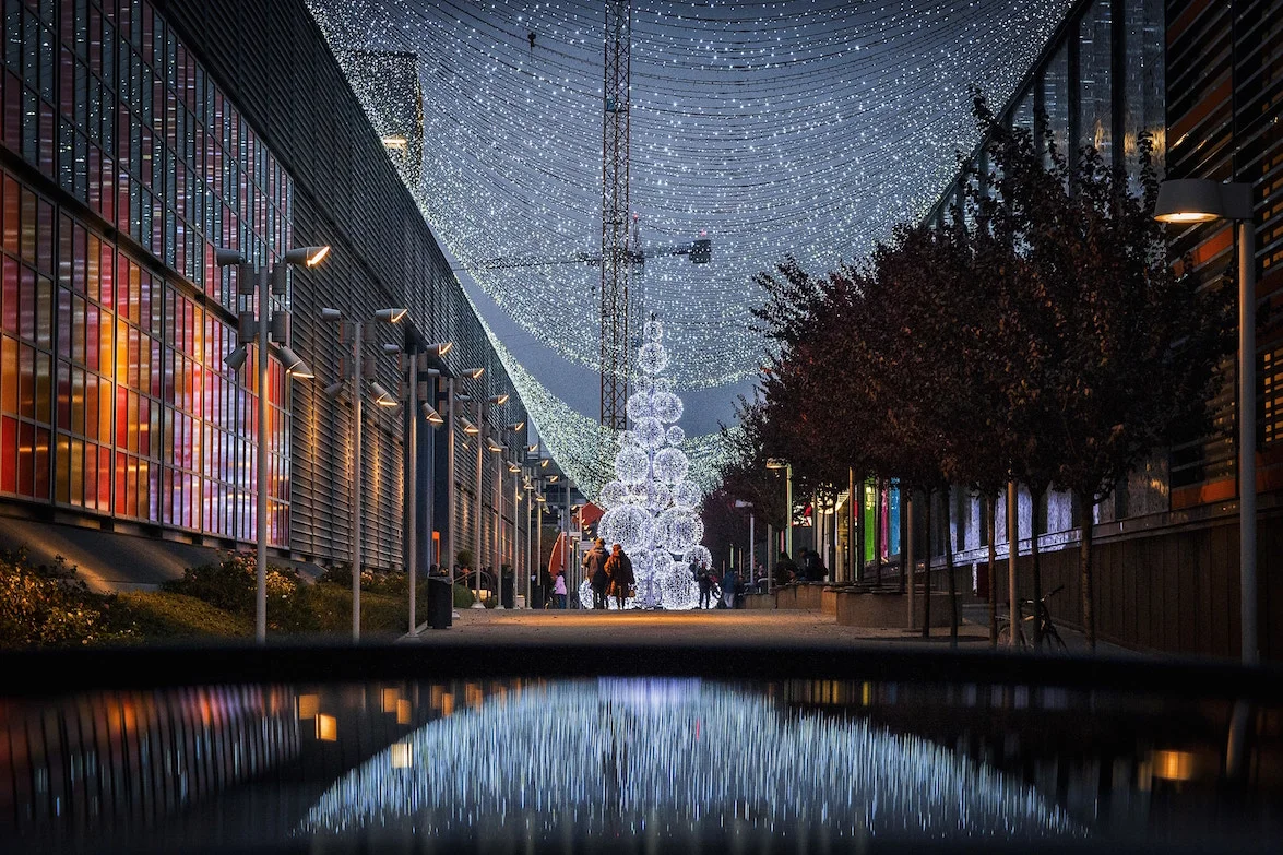 Overhead holiday lights used as visual support for large-scale retail placemaking