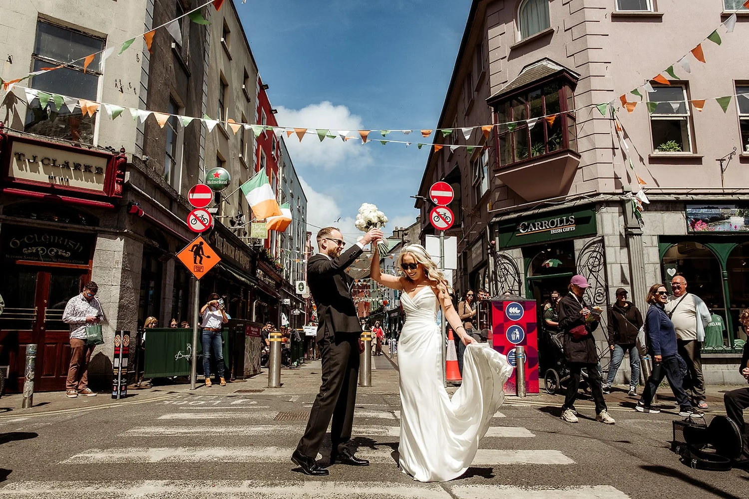 Shane spinning Siobhán in the middle of a sunny Galway street under the bunting