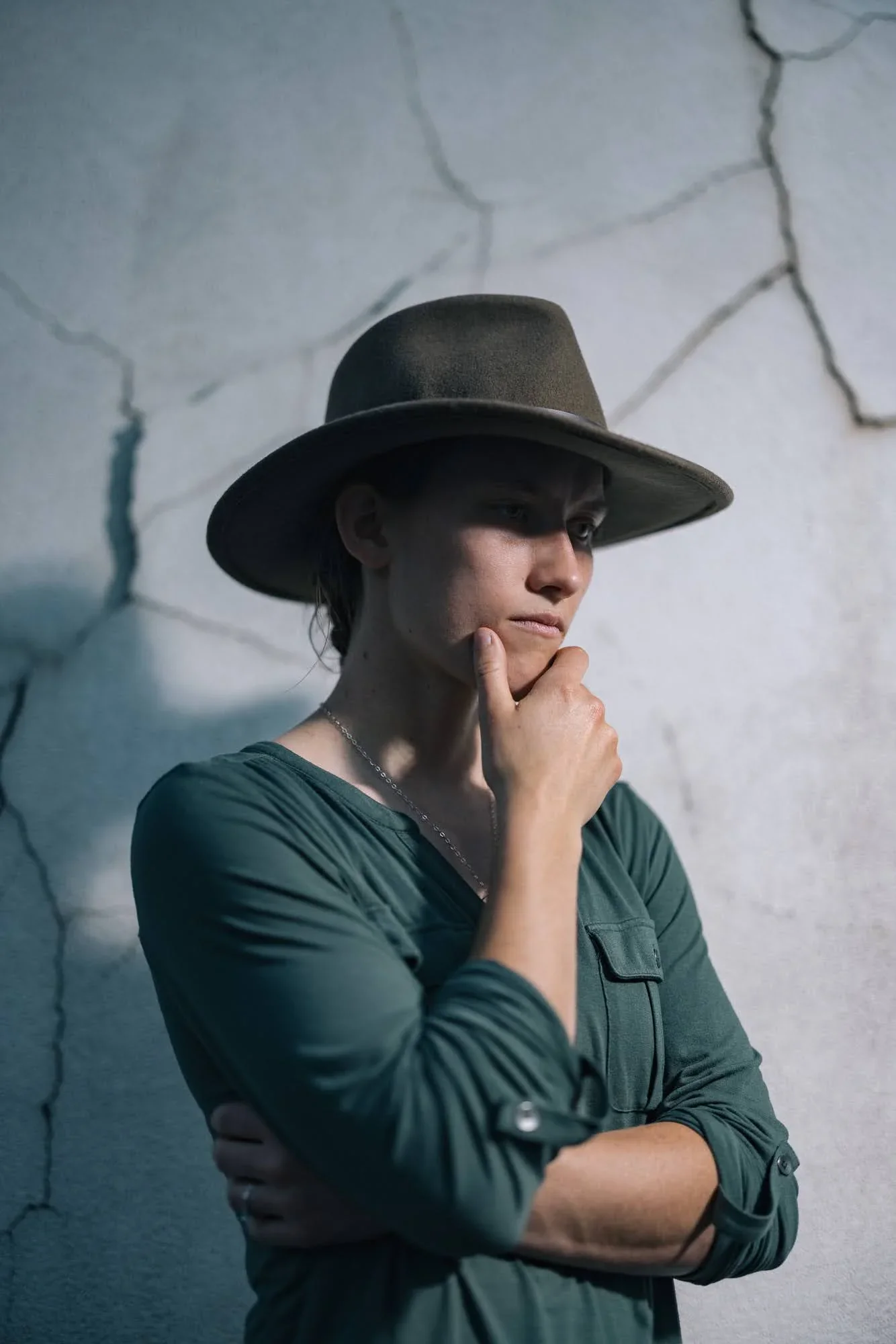 Thoughtful editorial portrait of cyclocross athlete Hannah Arensman in a hat, Morganton NC, by Jack Robert for The Telegraph