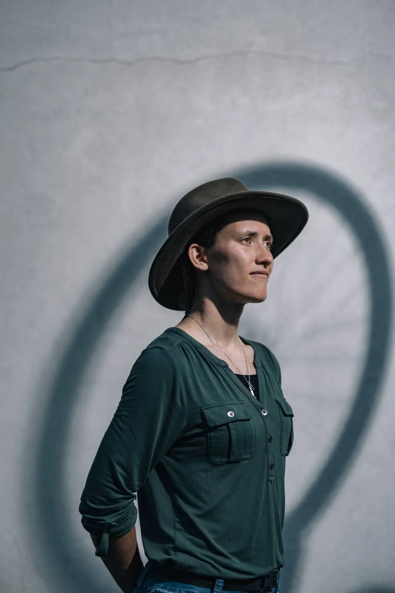 Dramatic shadow portrait of Hannah Arensman in a hat, conceptual editorial photography Morganton NC by Jack Robert